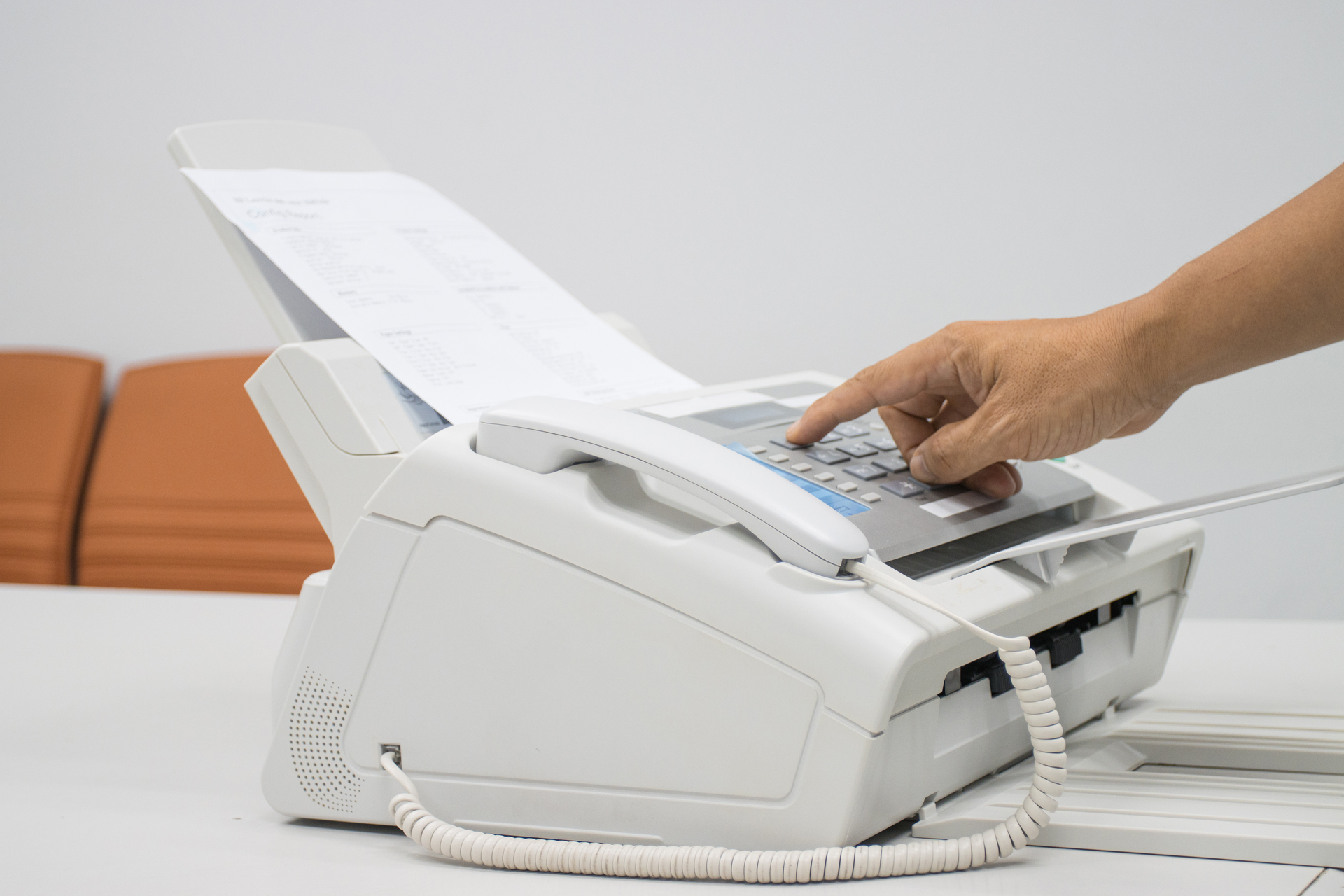 hand man are using a fax machine in the office, equipment for da